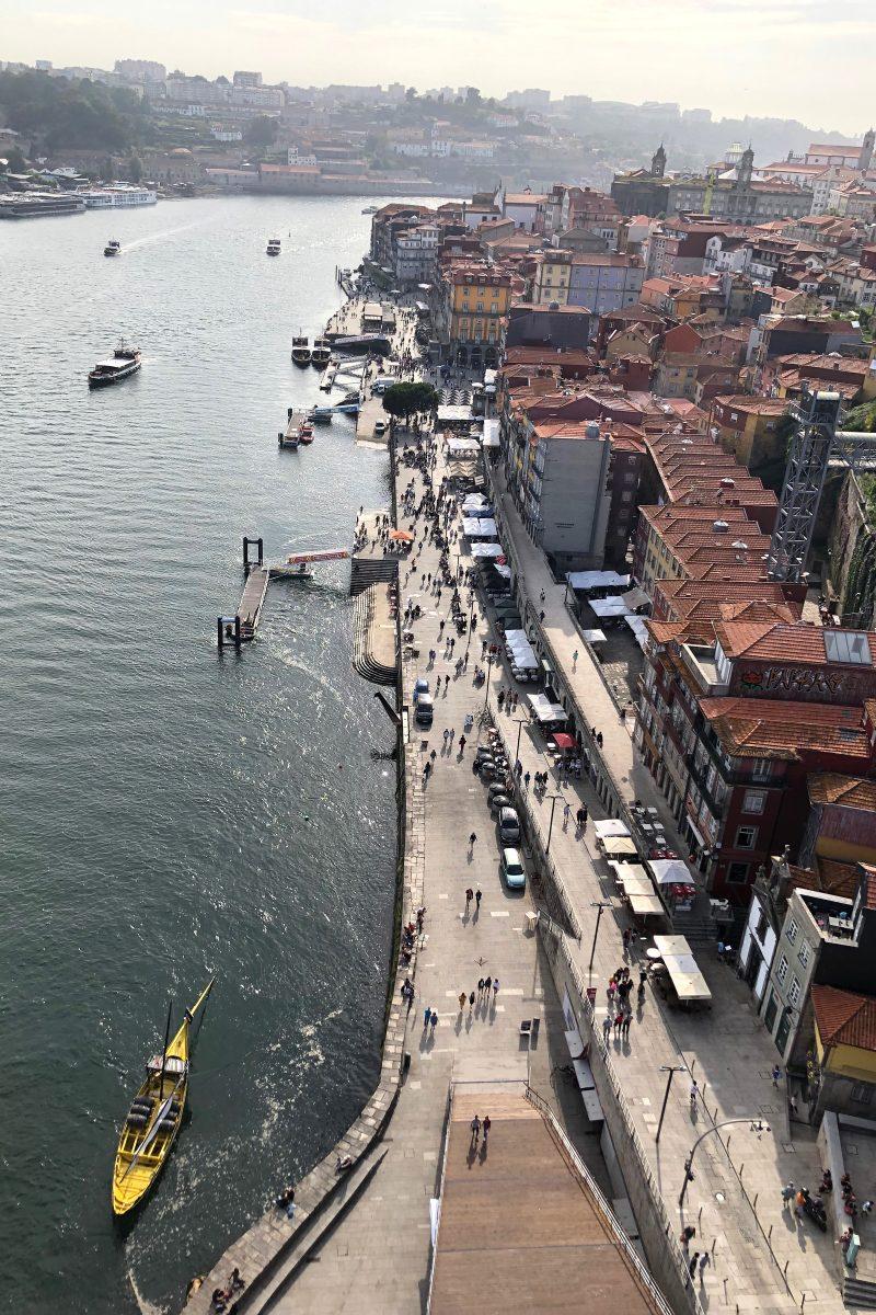 Restaurants and bars line the north bank of the Douro river in Porto, Portugal, near the Dom Luis I Bridge. Boat tours for tourists are available at docks along the river.&#160;Photograph by Jade Yamazaki Stewart.