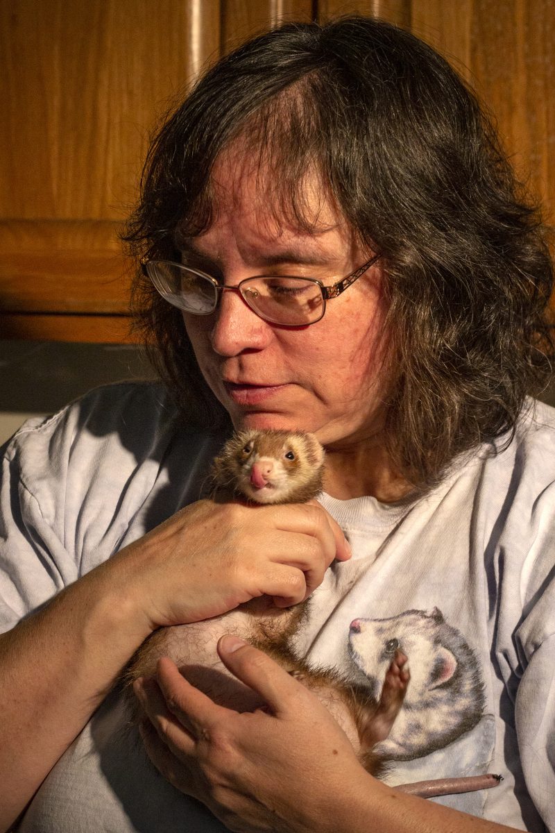 Ellis holds one of her ferrets for a portrait. Ellis loves and cares for her ferrets but her connection with them goes beyond their cute appearance. Ellis says the pet ferrets she had as a teenager acted as emotional support after her mom passed away. &#8220;If it wasn&#8217;t for ferrets, I probably wouldn&#8217;t be here today,&#8221; Ellis says.&#160;Photograph by Payton Bruni