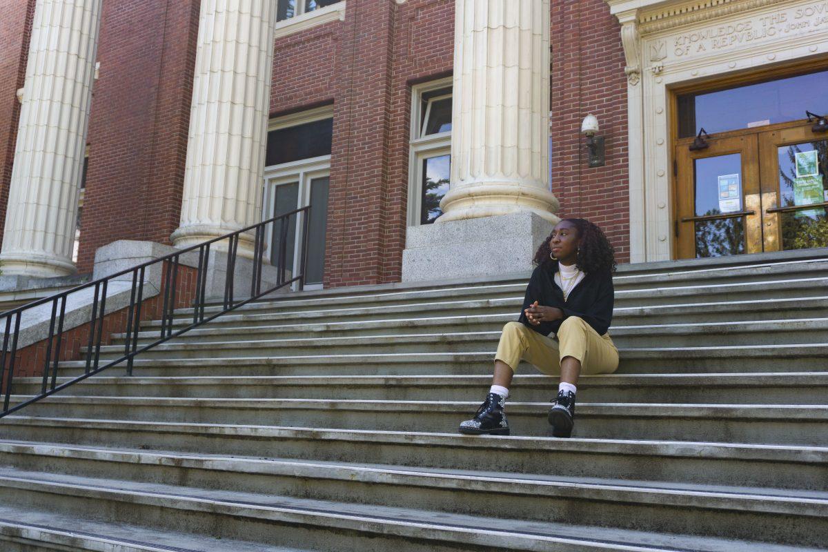 Koyin Olopade, a second year student, sits on the steps of University Hall, formerly known as Deady Hall. After years of requesting the name of Deady Hall to be changed due to the racist views of the building&#8217;s namesake, Matthew Deady, the University of Oregon Board of Trustees finally voted to rename it in June 2020.