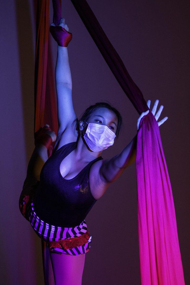 Sakurako Marcello, known as Rocky, holds a wrist belay while doing a split pose, or kite. Rocky joined the Revelers after taking aerial classes in Japan.