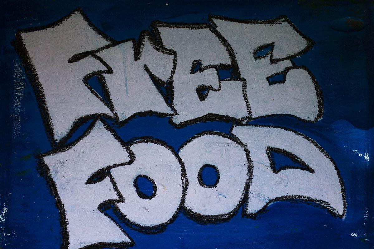 The words &#8220;Free Food&#8221; are painted on the front of the community fridge located on 18th and Alder. According to Eugene Community Fridge, even though people are hesitant to host fridges due to the risk of litter build up, the fridge sites are often trash free and are cleaned every time a volunteer from the organization comes to fill the fridge.