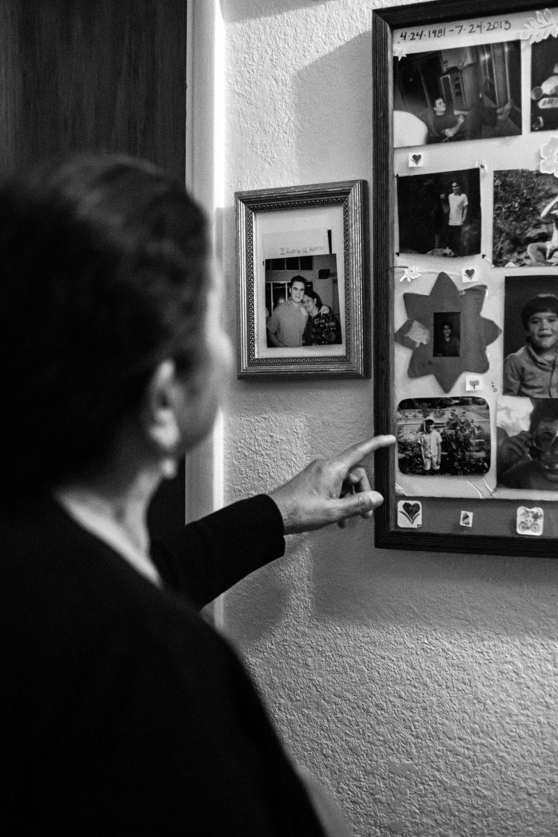 Helen Tendick looks at the photo collage of her late son, Nicholaus. According to Tendick, all of the photos embody Nicholaus, or Nick, with his big laugh or being with his family. &#8220;Nick had a big heart. I remember he came back one night without shoes and a shirt because there were kids outside that were cold. He would literally give the shirt off his back. That&#8217;s the kind of person he was,&#8221; Tendick says.