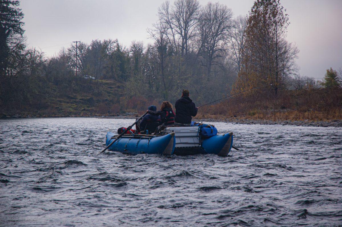 A boat of fishermen floats through the ice cold Mckenzie River that supports nurturing bull trout and Chinook salmon.