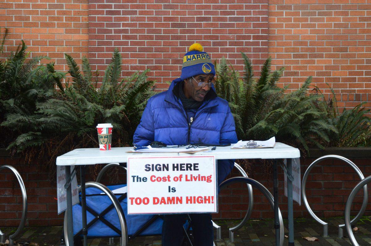 Bennie Jordan sits outside the Student Rec Center collecting signatures for a petition to lower the cost of living.