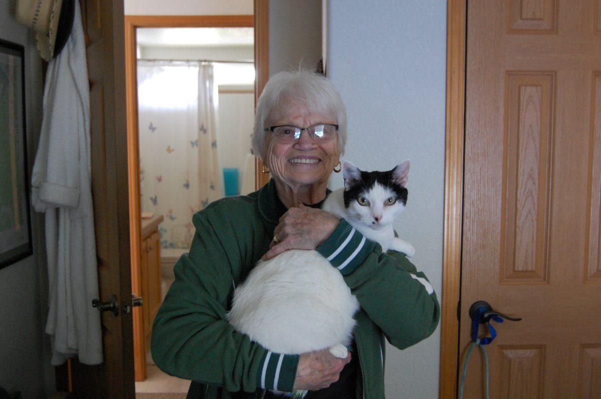 Nancy Hohenberry, 85, holds her cat, Meow Meow, at a friend&#8217;s home in Seal Rock where she returned to live after leaving the Eugene Hotel in early 2023.