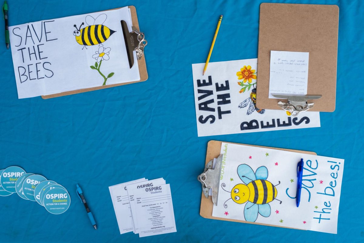 Students with the Oregon Student Public Interest Research Group (OSPIRG) table across 13th Street and the Erb Memorial Union on April 9, 2025. OSPIRG gathered signatures in support of a statewide ban on neonicotinoid pesticides, which are highly toxic to bees.