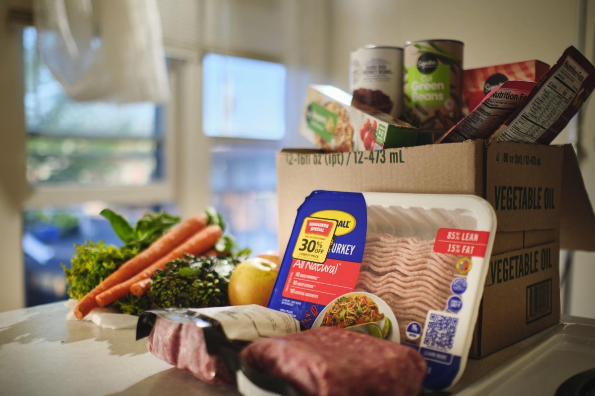 A box is filled with food by The Arc of Lane County's food pantry, a Food for Lane County affiliate. The Arc of Lane County's food pantry is open from 2 p.m. to 6 p.m. on Tuesdays and Thursdays.